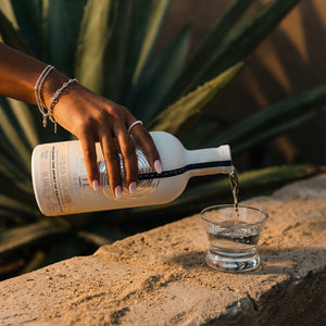 Woman pouring Whiteout tequila into a shot